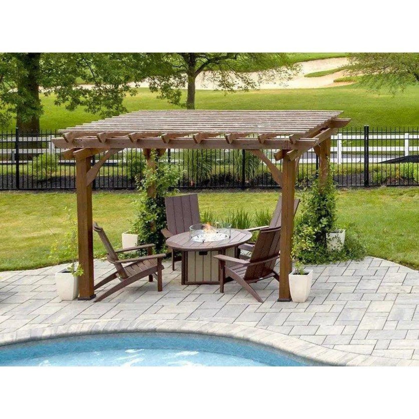 Outdoor patio setup with wooden pergola, table, chairs, and fire pit near a pool.