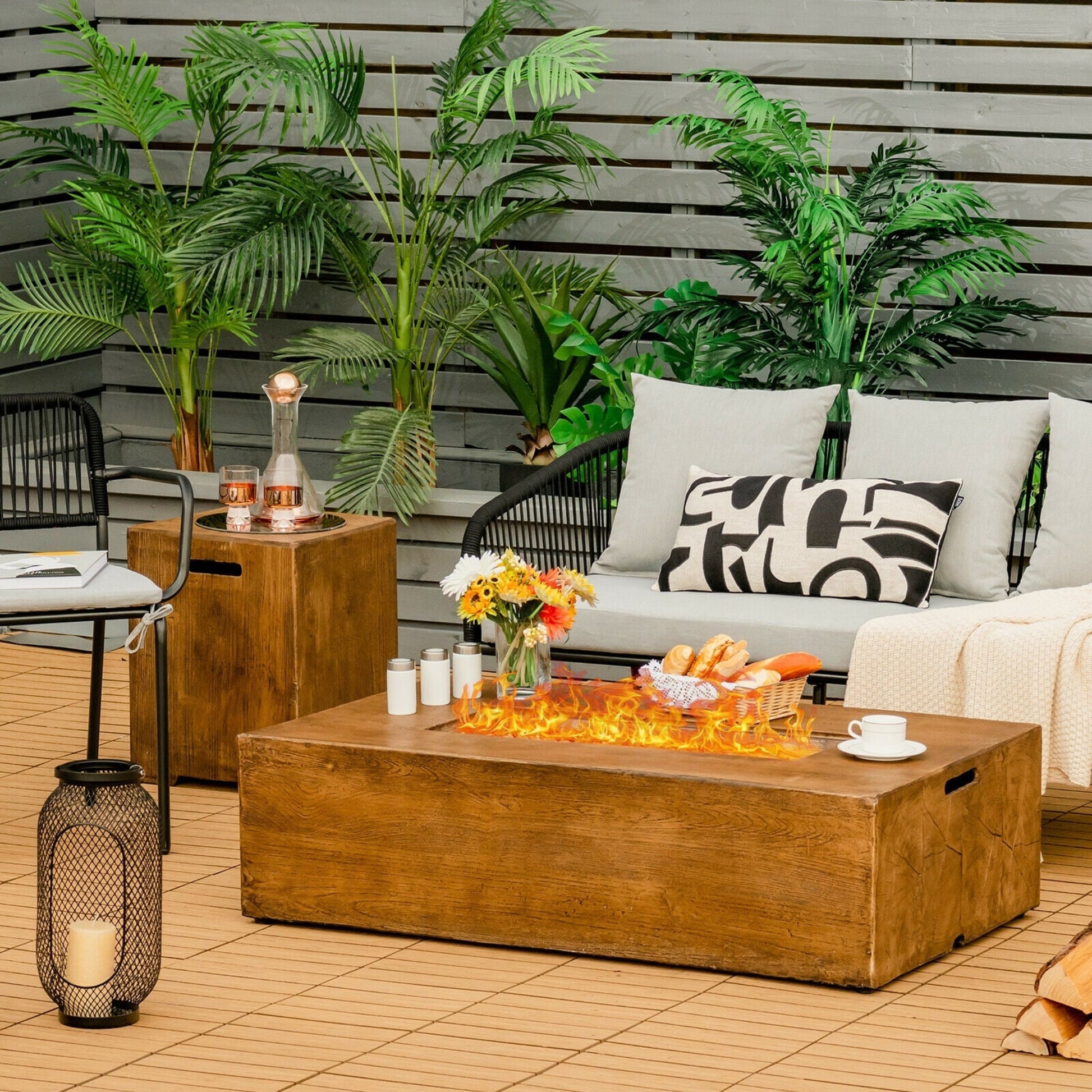 Outdoor patio setting with a fire pit, seating area, and decorative elements.
