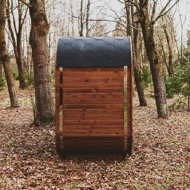 Side view of wooden sauna in natural wooded setting